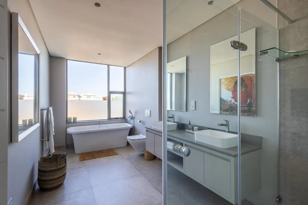 Modern bathroom with freestanding tub, double vanity, and walk-in shower