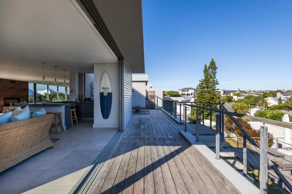 Spacious wooden deck with ocean views and coastal town landscape