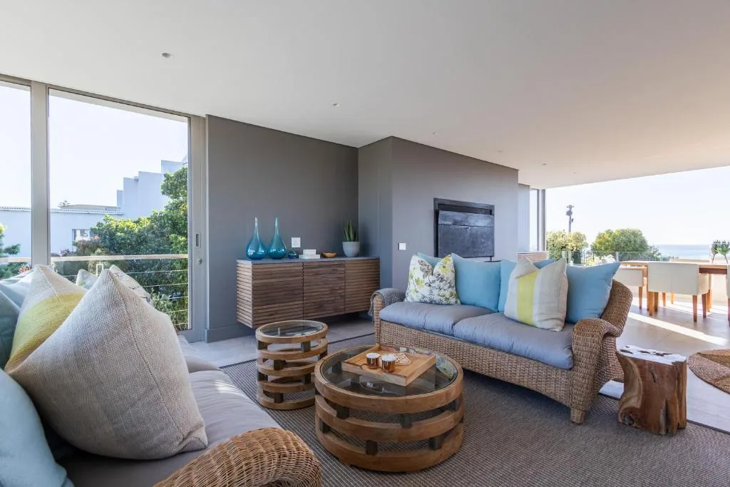 Spacious modern lounge with rattan seating and ocean views through large windows