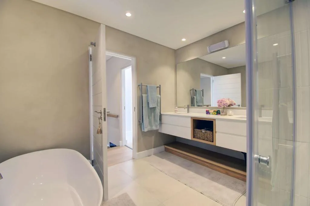 Modern bathroom with freestanding tub, double vanity, and walk-in shower