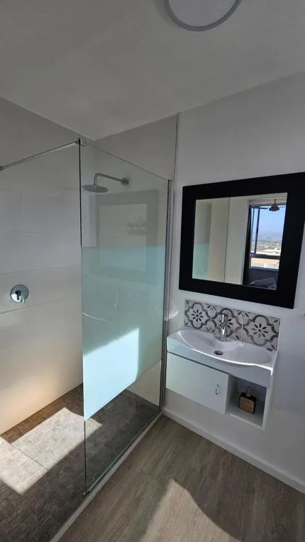 Modern bathroom with glass shower enclosure and white vanity sink