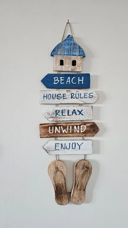 Coastal wooden sign decoration with beach house rules and sandals