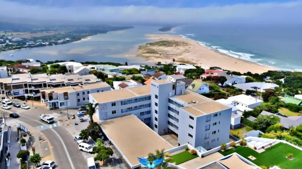 Aerial view of coastal town with beach, lagoon, and ocean horizon