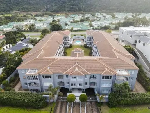 Aerial view of modern apartment complex with terracotta roof in Plettenberg Bay