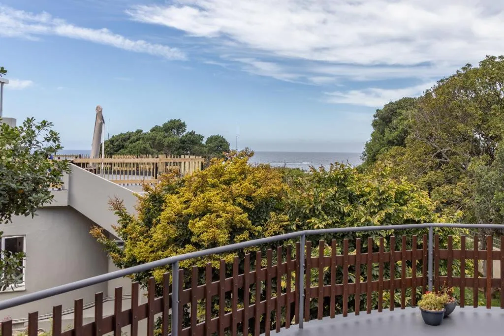 Scenic coastal view from deck overlooking ocean and lush vegetation