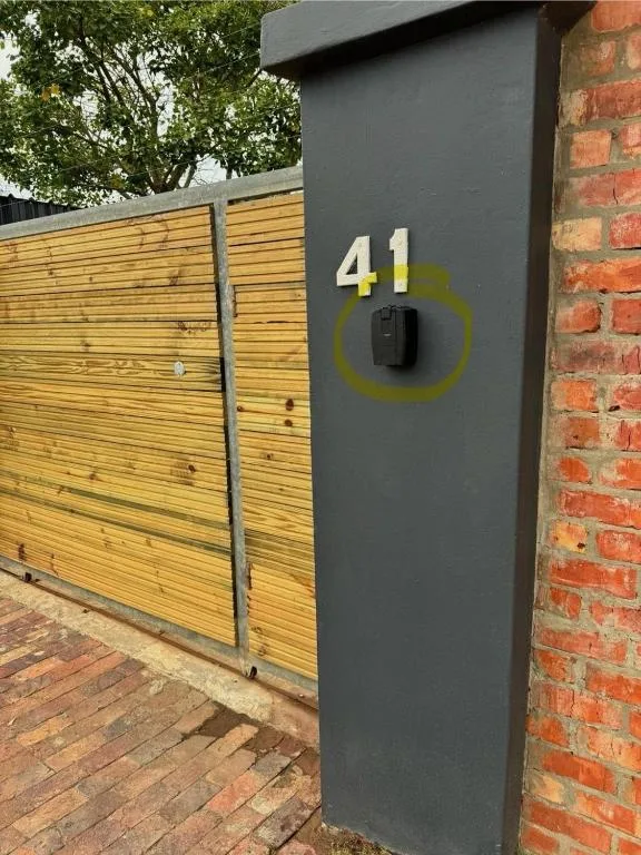 Modern black gate pillar with house number 41 and intercom system