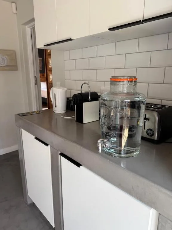 Modern kitchen counter with white subway tiles and appliances