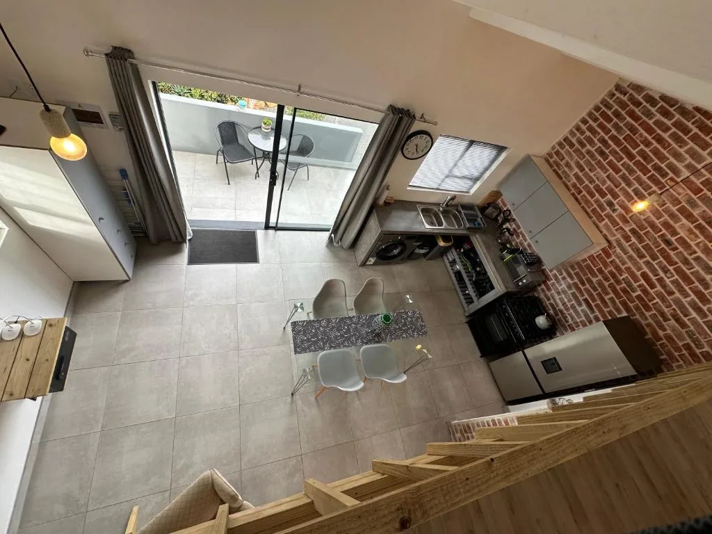 Modern kitchen with stainless steel appliances and granite countertop, open-plan layout