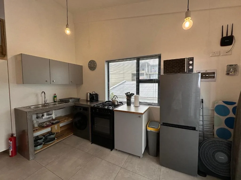 Modern kitchen with stainless steel appliances and gray cabinetry