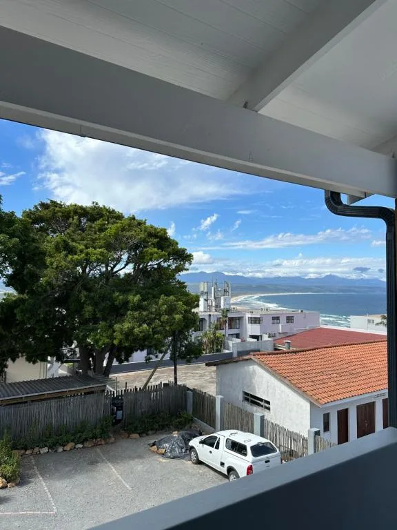 Scenic coastal view of Plettenberg Bay with mountains and blue ocean