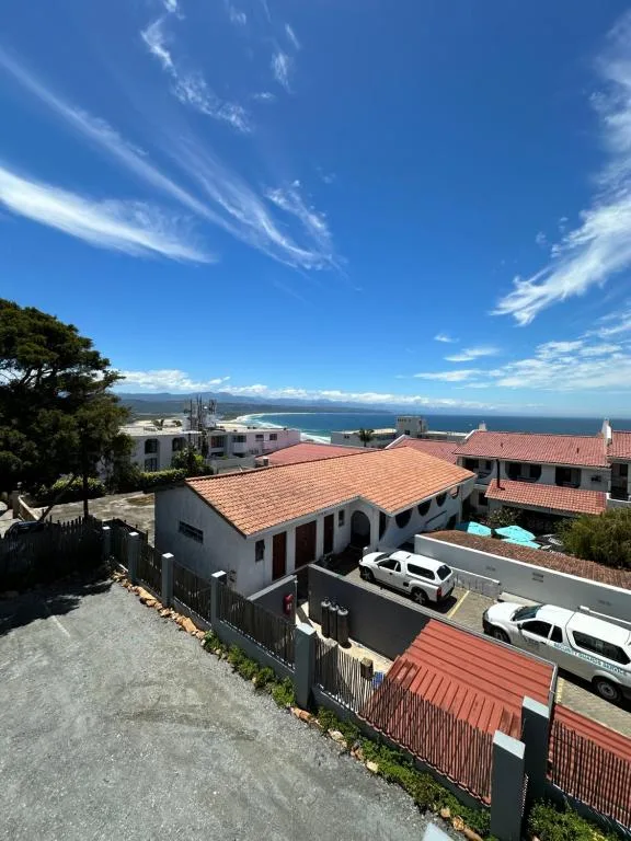 Coastal vista with lagoon and mountains under clear blue sky