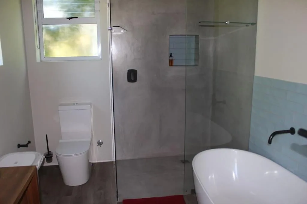 Modern bathroom with freestanding bathtub and walk-in shower enclosure