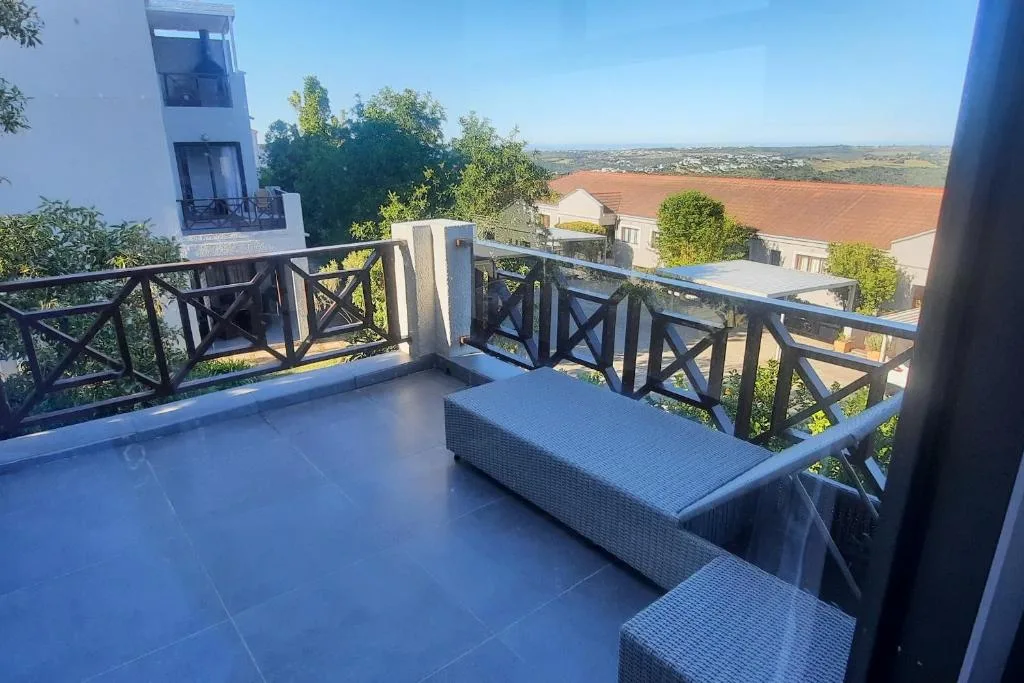 Spacious outdoor deck with seating and expansive countryside views