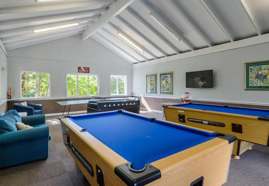 Spacious games room with pool tables and comfortable seating