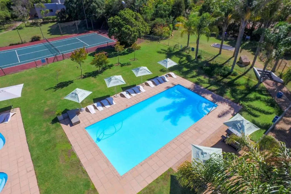 Rectangular swimming pool with sun loungers and umbrellas on deck