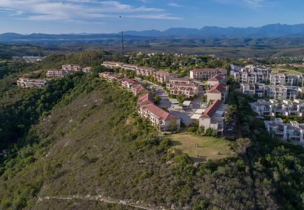 Aerial view of Mount Castleton complex with distant mountains and valley landscape