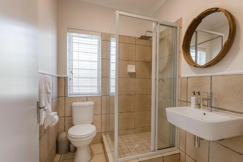 Modern bathroom with shower enclosure, toilet, and vanity sink