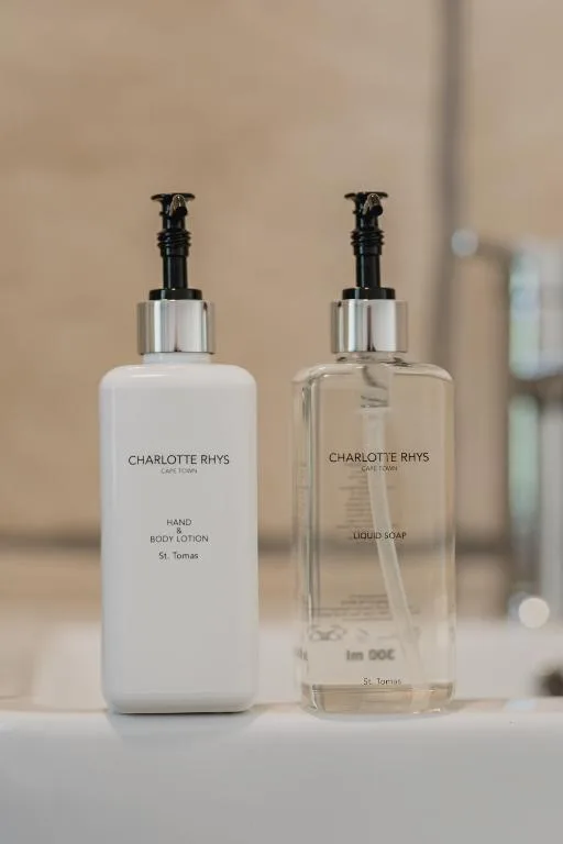 Charlotte Rhys hand lotion and liquid soap dispensers on bathroom vanity