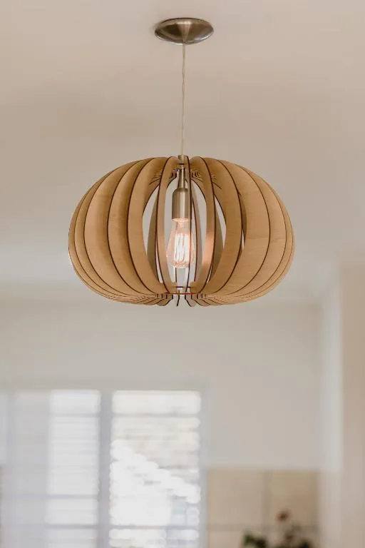 Modern wooden pendant light fixture with warm brass accents
