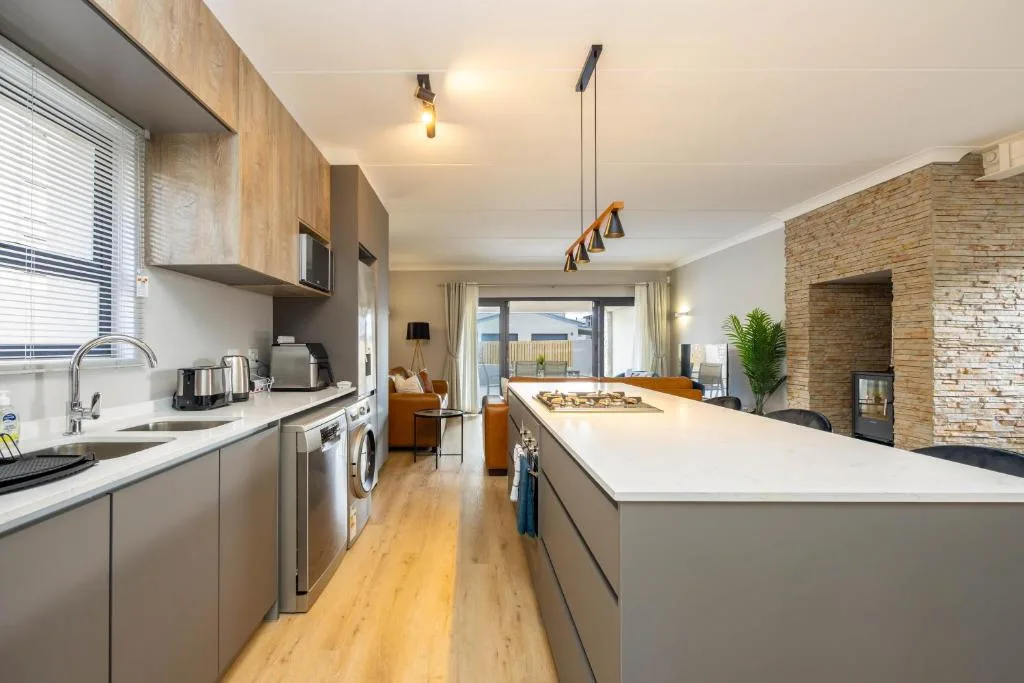 Modern open-plan kitchen with island counter and stainless steel appliances