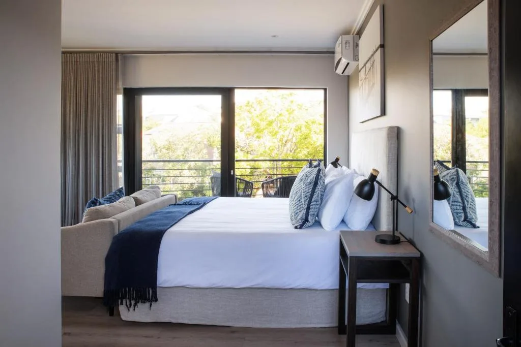 Spacious bedroom with queen bed, deck access, and mountain views