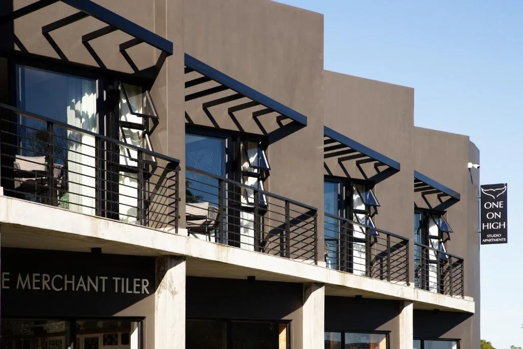 Modern apartment building facade with geometric sunshades and steel railings