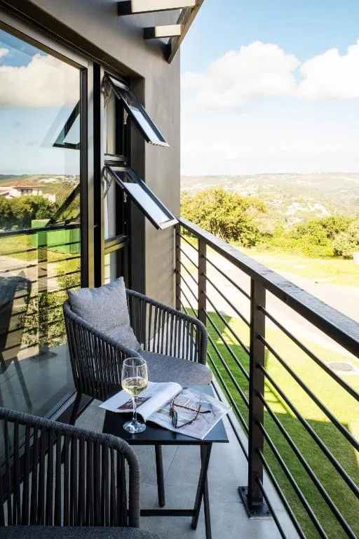 Scenic hillside and valley landscape visible from balcony seating area