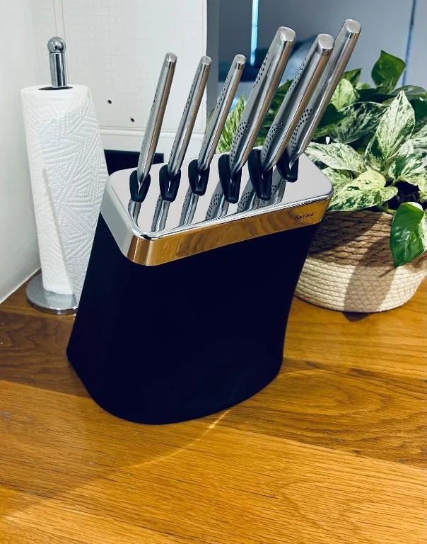 Modern kitchen knife block with stainless steel knives and potted plants