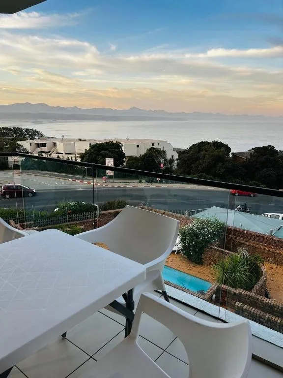 Sweeping ocean and mountain vista from elevated outdoor deck area