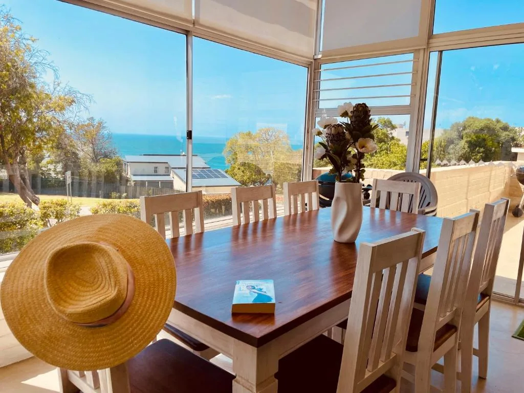 Dining room with ocean views through large windows and coastal scenery