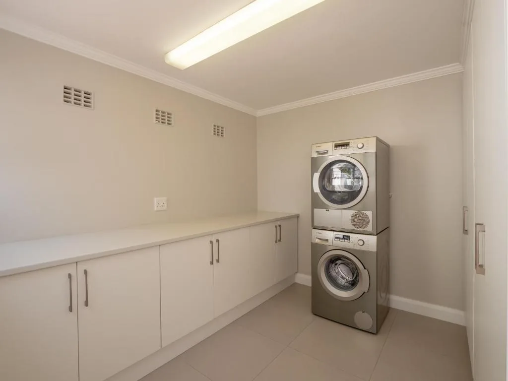 Modern laundry room with stacked washer and dryer appliances
