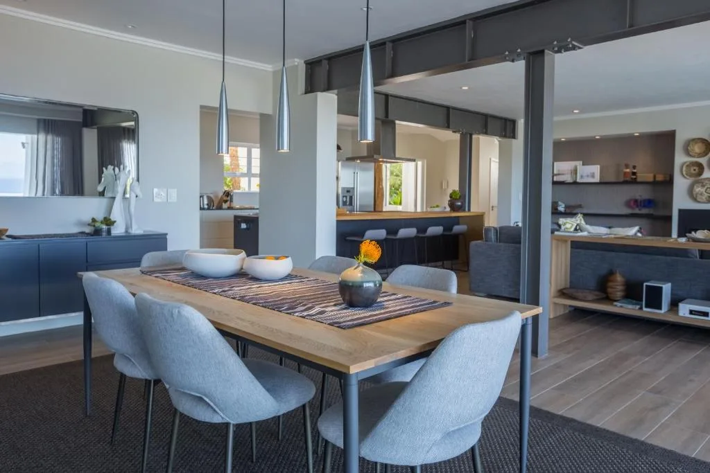 Modern dining table with light blue chairs and pendant lighting overhead
