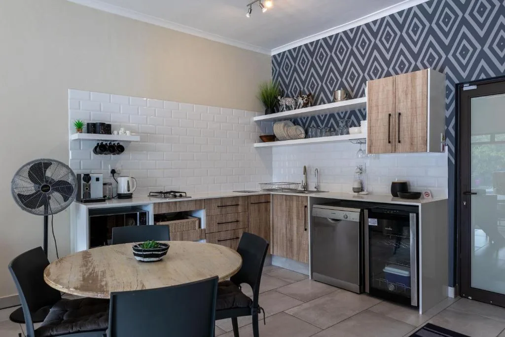 Modern kitchen with wooden cabinetry, white subway tiles, and dining table