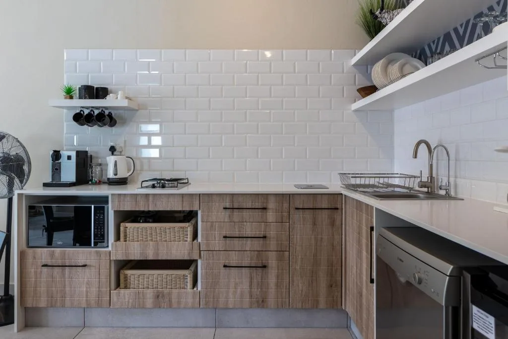 Modern kitchen with white subway tile backsplash and wooden cabinetry