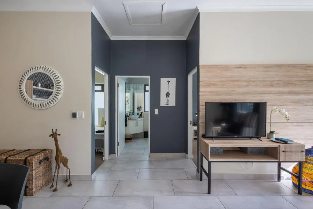 Modern lounge with TV, decorative accents, and open floor plan