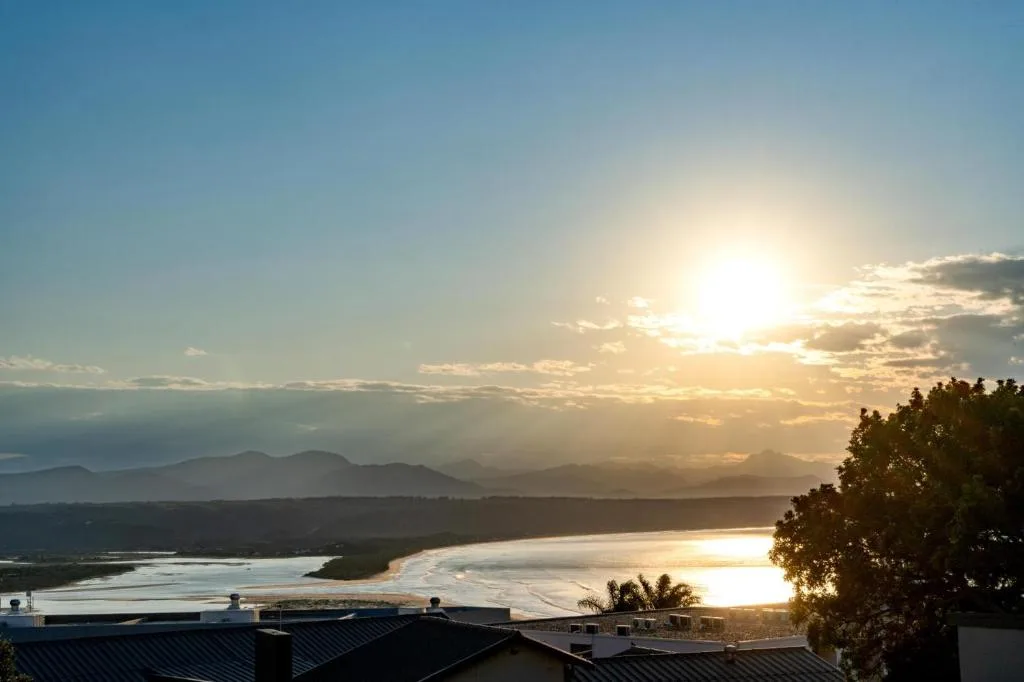 Scenic sunset over Plett Bay with mountains and lagoon from property