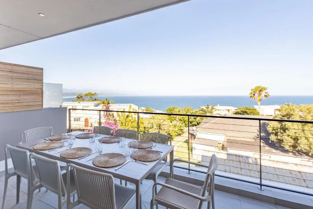 Outdoor dining area with ocean views overlooking Plettenberg Bay