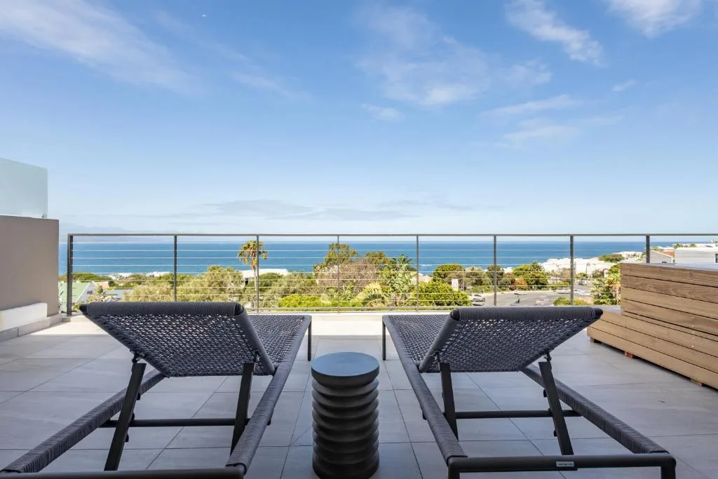 Oceanview terrace with lounge chairs and coastal horizon beyond