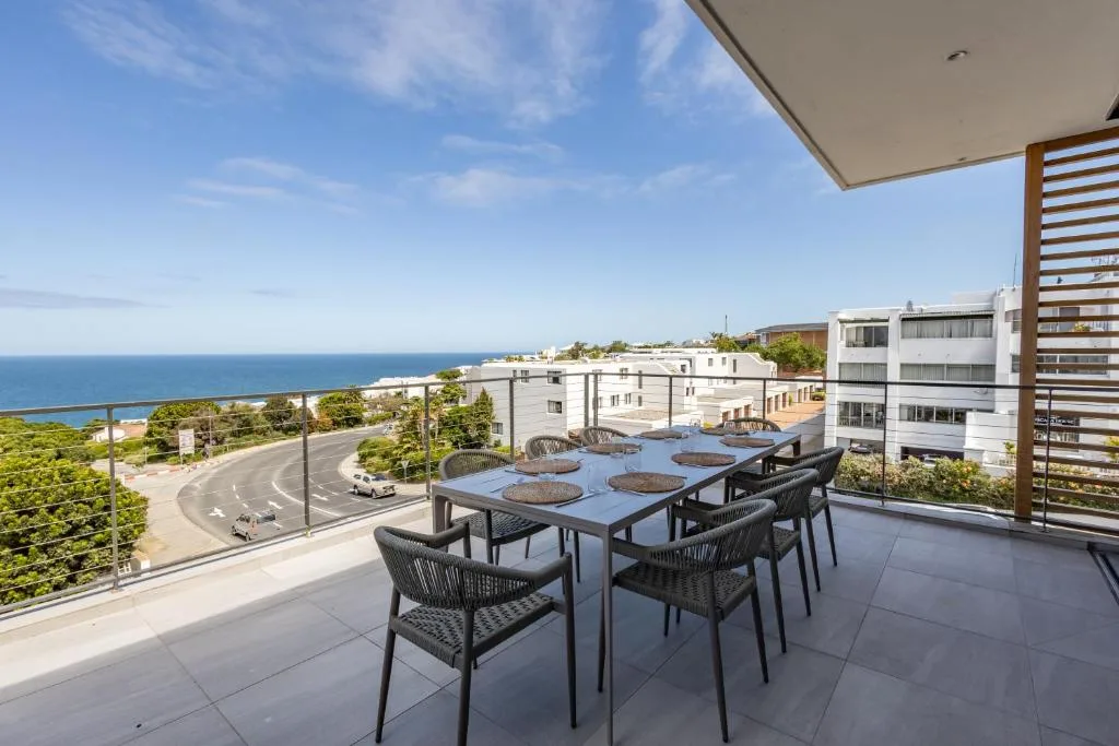 Oceanview terrace with dining table and chairs overlooking Plettenberg Bay
