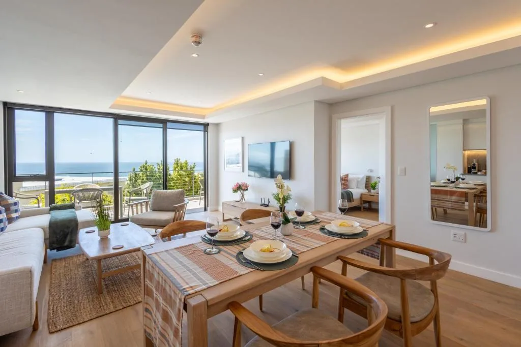 Modern dining table with ocean view through floor-to-ceiling windows