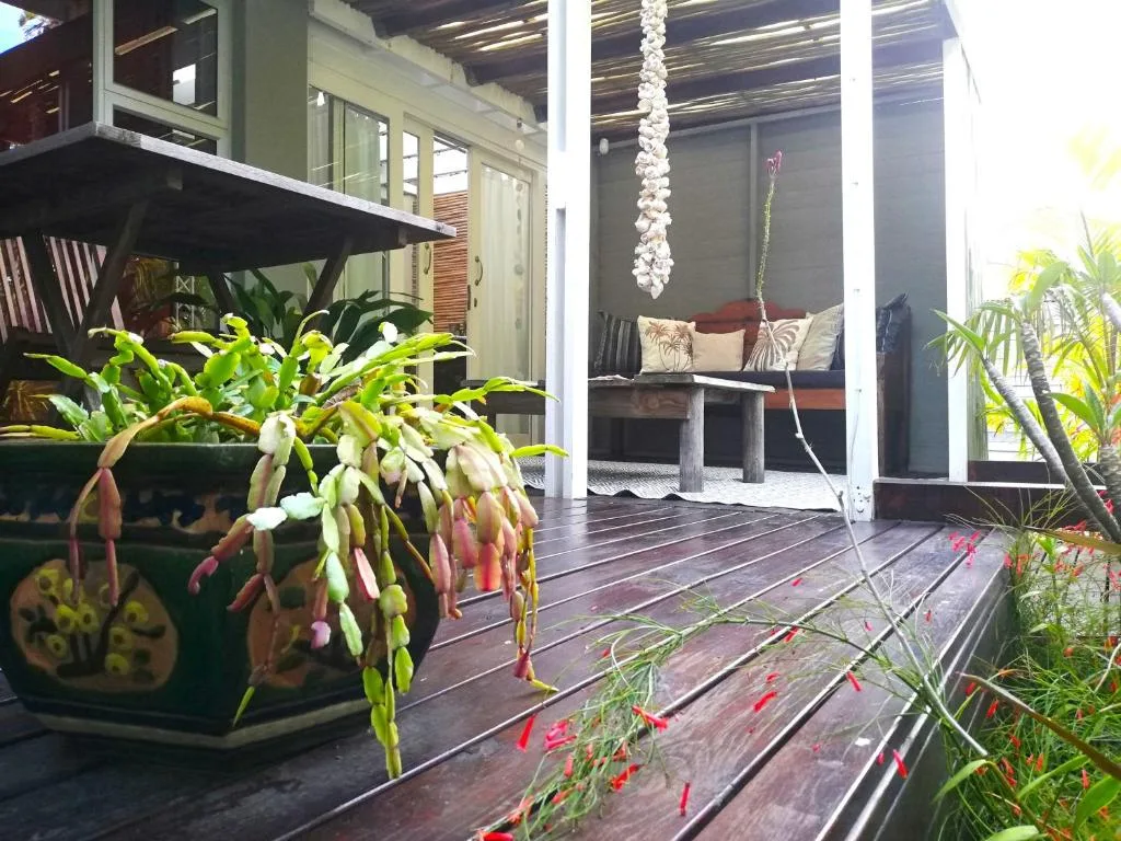 Wooden deck with potted plants and outdoor seating area
