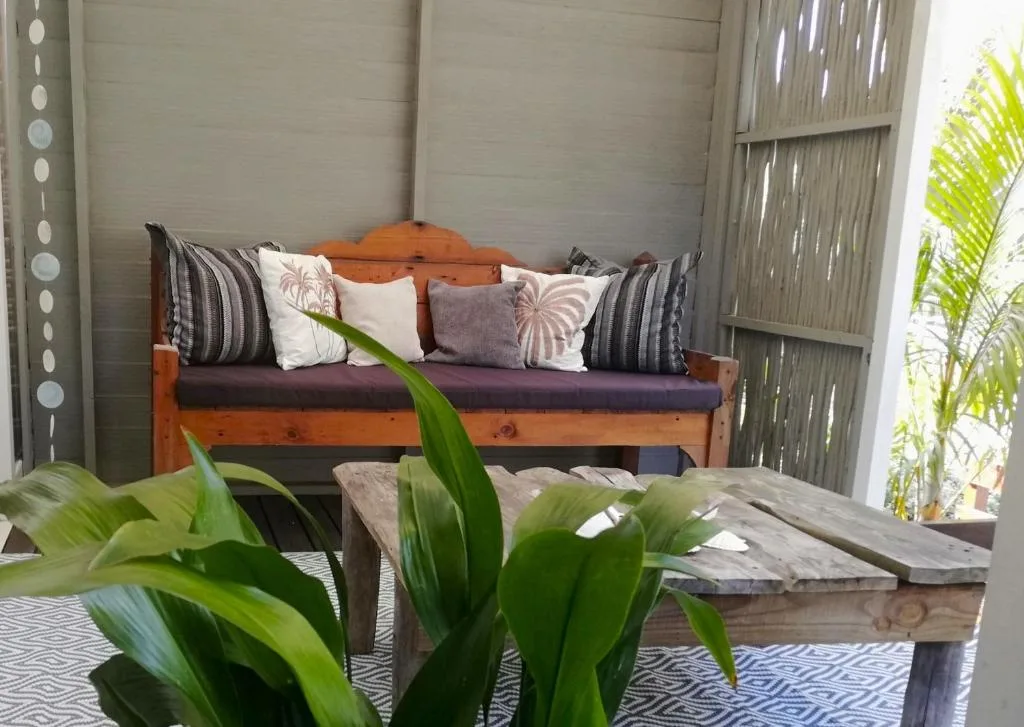 Wooden bench with cushions and decorative pillows in bright lounge space