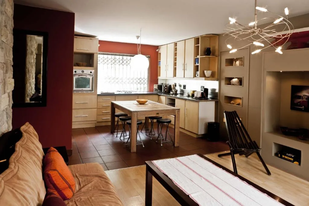 Open-plan living area with sofa, kitchen island, and modern furnishings