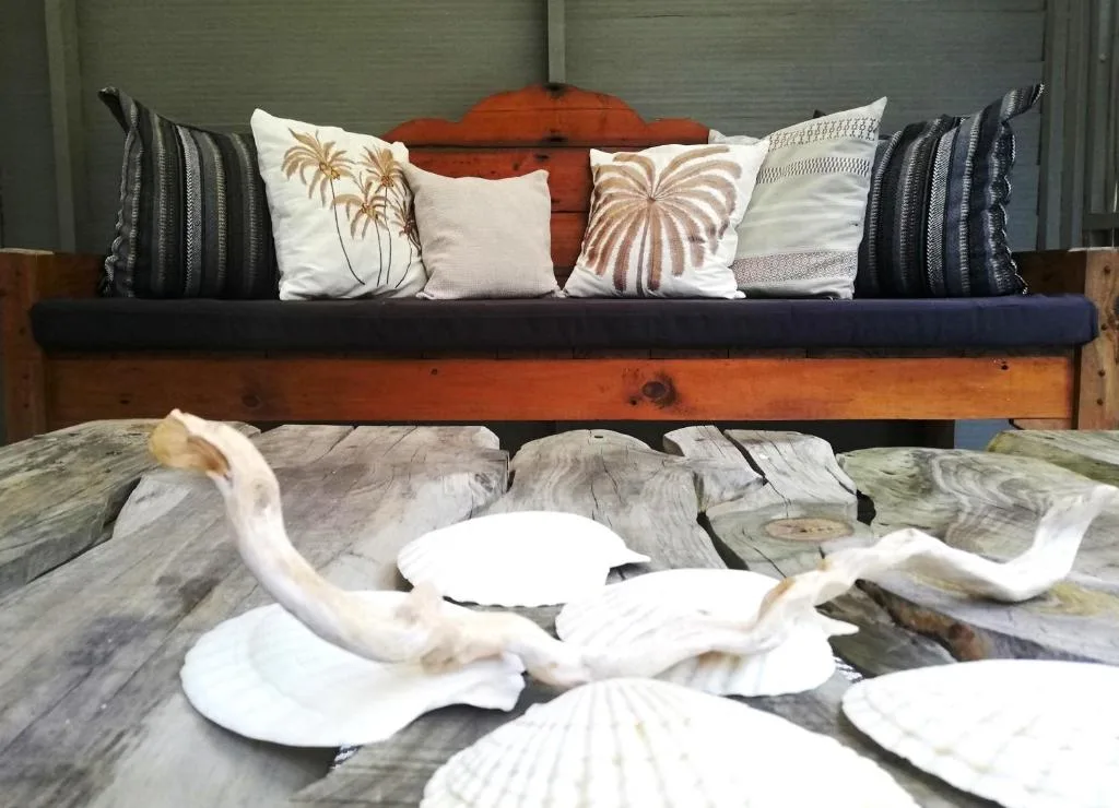 Coastal-themed lounge with decorative seashells and patterned cushions