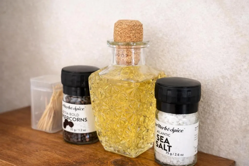 Gourmet spices and oil bottles arranged on wooden surface