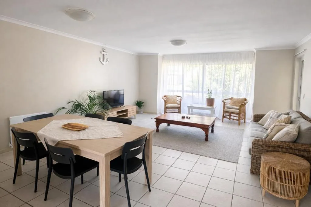 Open-plan lounge and dining area with comfortable seating and natural light