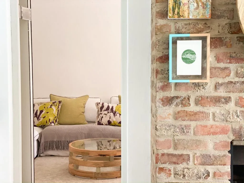 Cozy bedroom with cushioned daybed and exposed brick accent wall