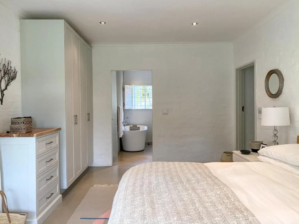 Spacious master bedroom with ensuite bathroom and modern furnishings