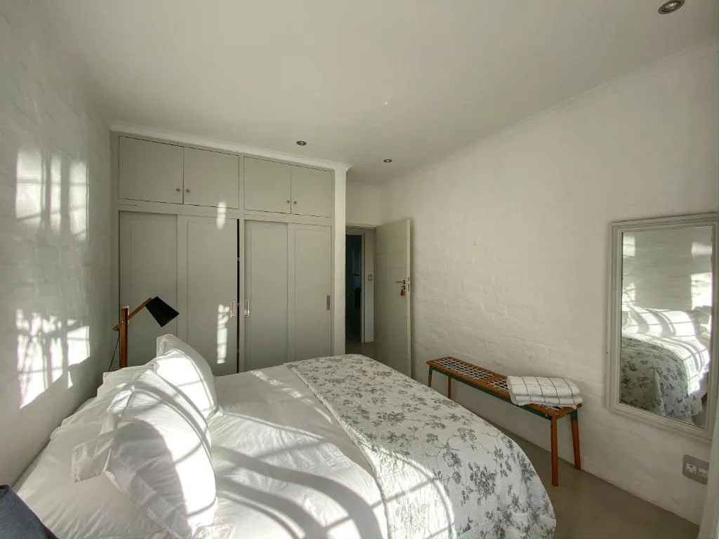 Bright bedroom with double bed, built-in wardrobes, and natural light