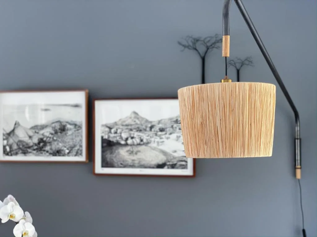 Hanging woven pendant lamp with landscape photography art on gray wall